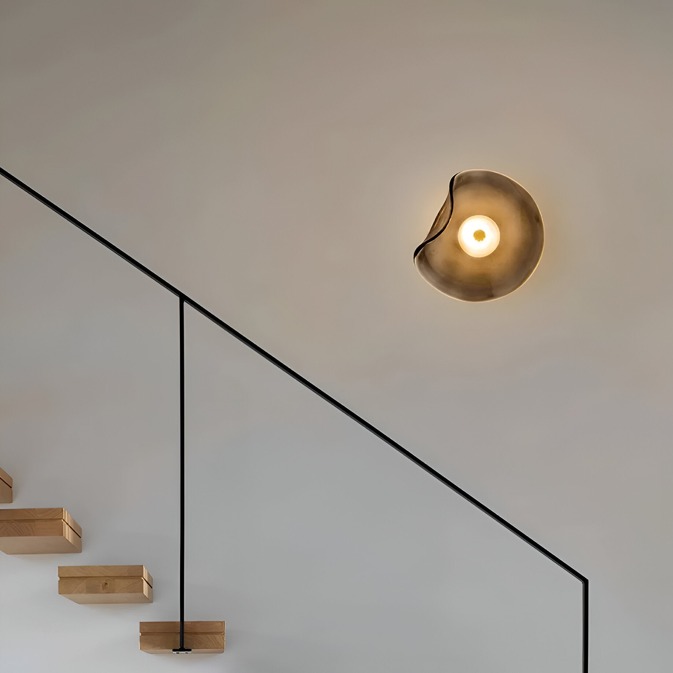 Buet glasvæglampe med LED i nordisk guld og sort til stuen