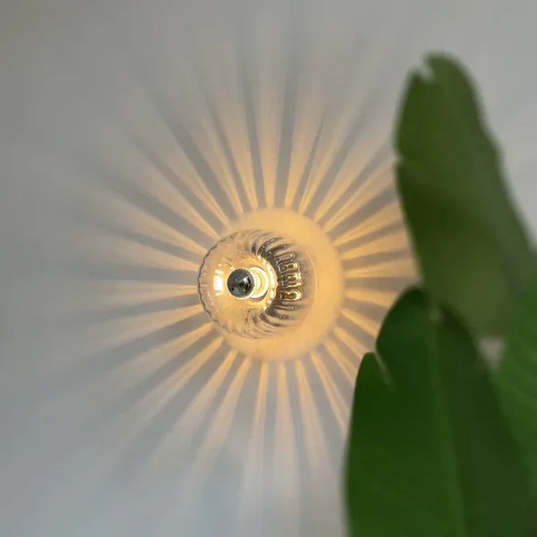 RadiantFlux Glass Wall Light With Rippled Sunburst Pattern And Gentle Ambient Glow