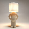 Lámpara de mesa LED divertida PeekaLume - luz humorística para la mesita de noche y el escritorio